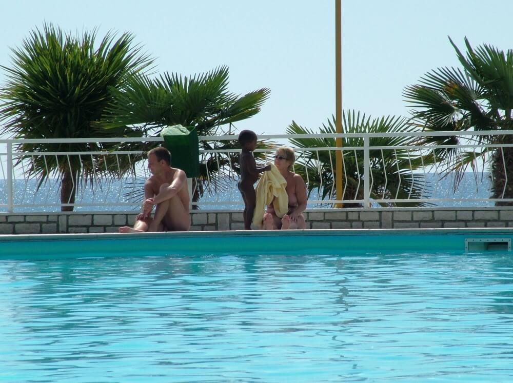Photo of naturists in an outdoor pool - Nudity helps one feel a sense of freedom and liberation